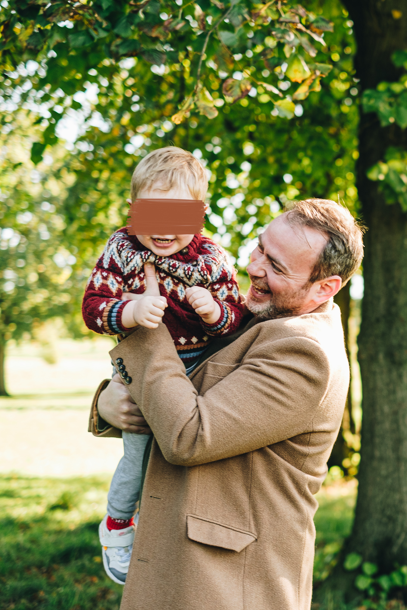 Father hold his son and both are laughing