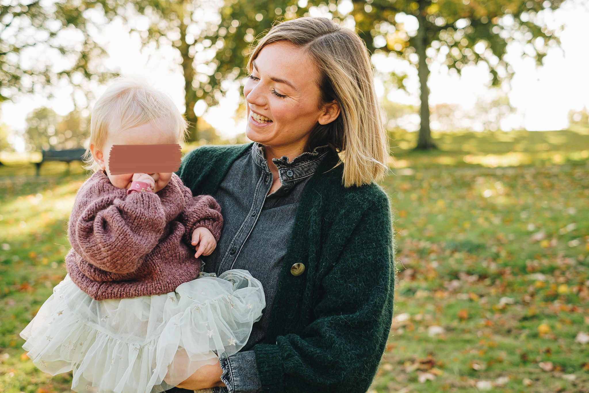 Mum and daughter surrounded by golden Autumnal light at Graves Park