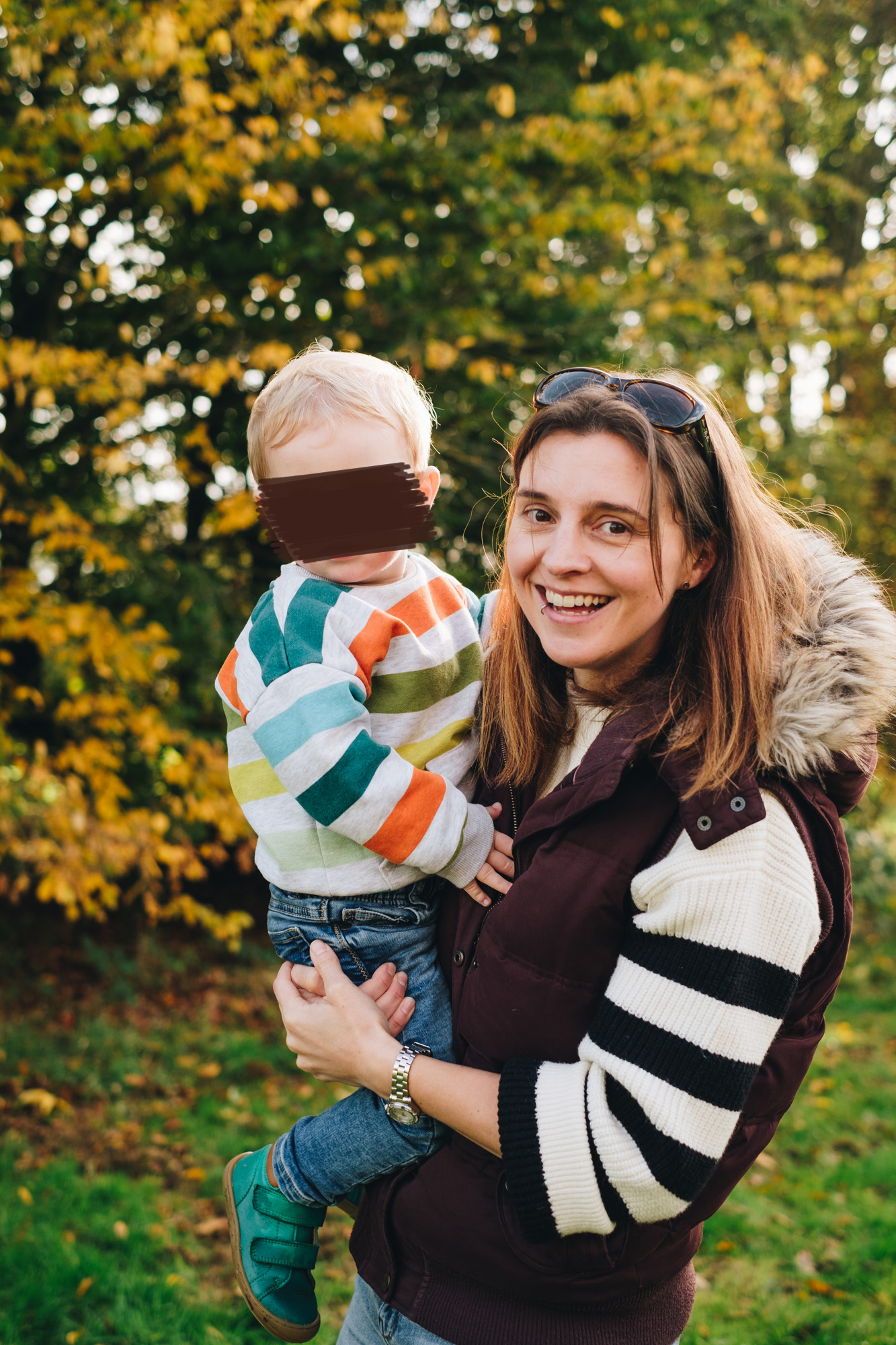 Mum holds her son smiling